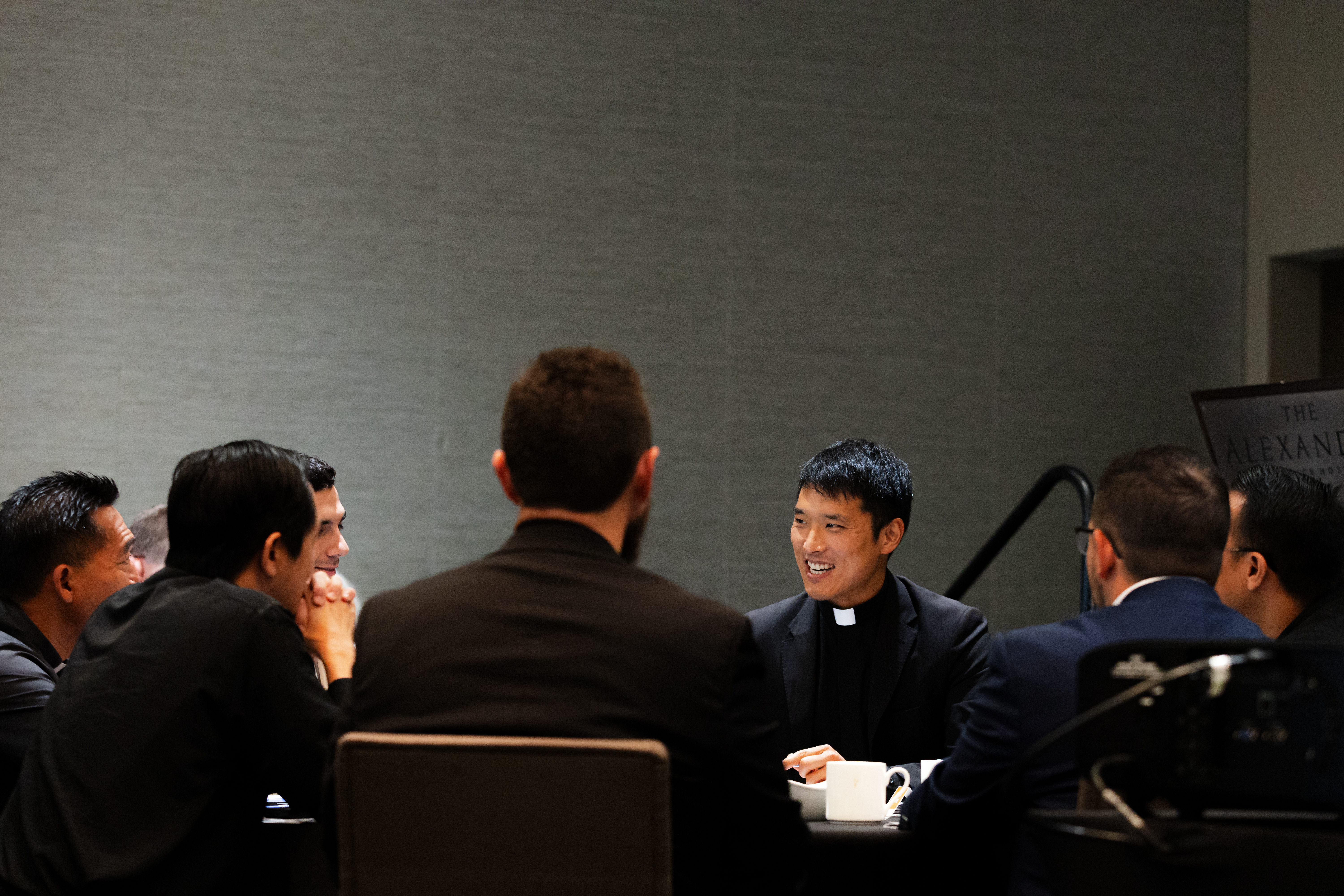 Men sitting around a table doing a Bible study as a New Years resolution