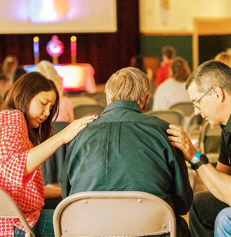 couple praying over person (1)