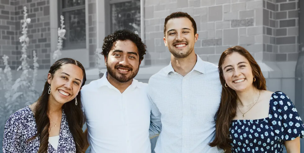 people smililng for photo, arm in arm