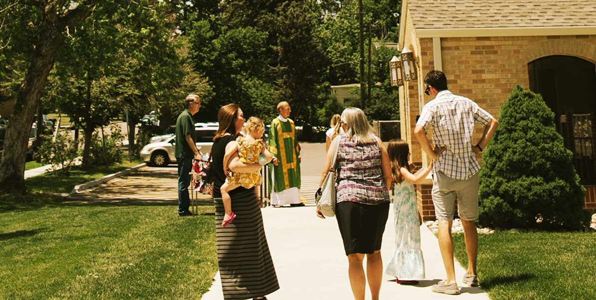 family walking town sidewalk on way to Church