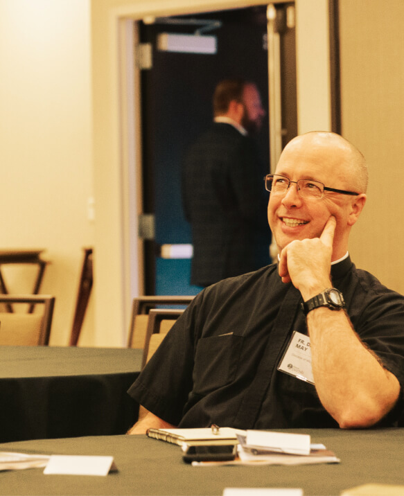 fr darrin smiling and listening in a small group